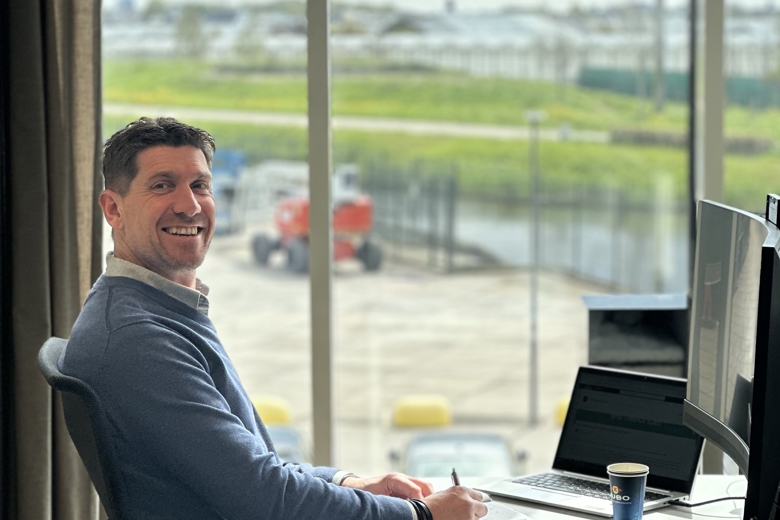 smiling man behind the computer